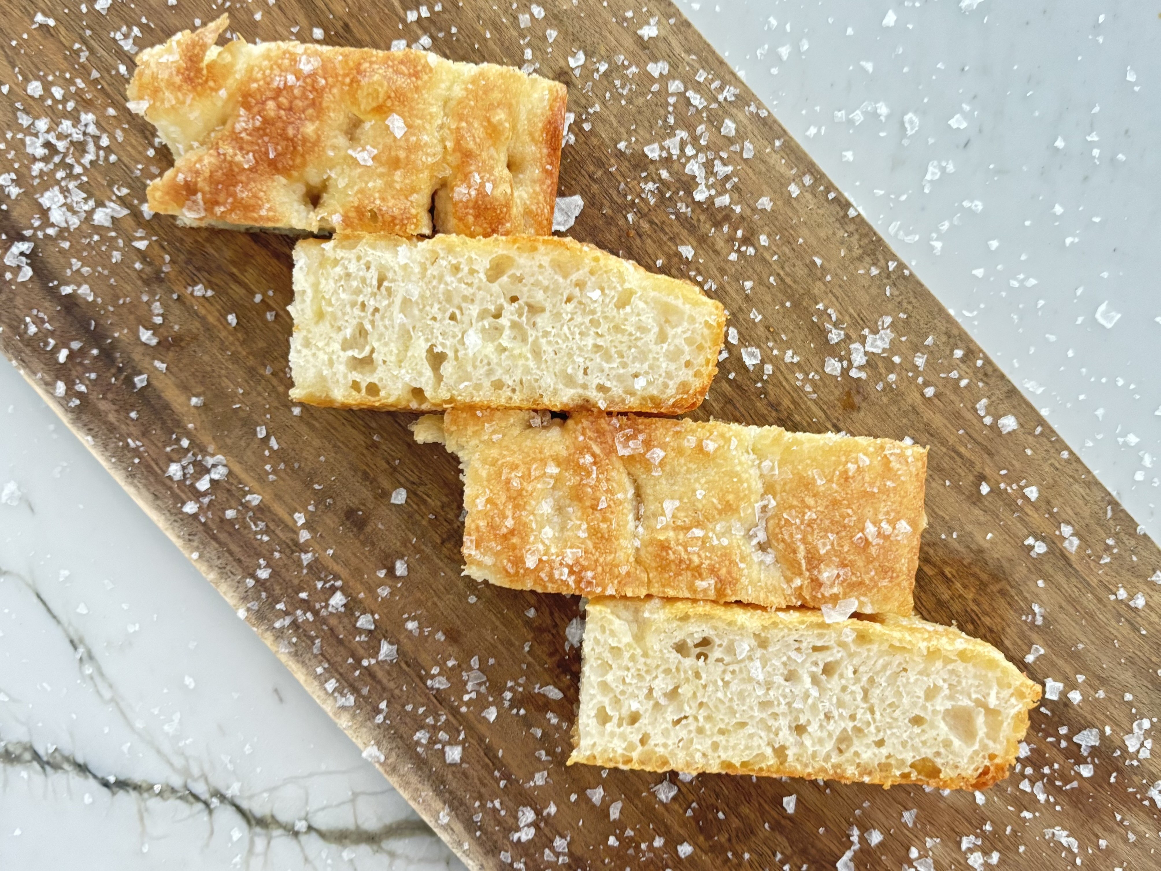 Slices of OG focaccia finished with flaky sea salt