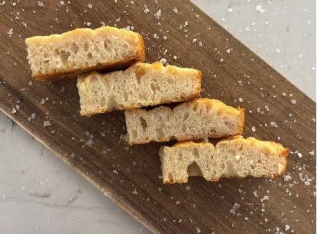 Slices of OG focaccia finished with flaky sea salt